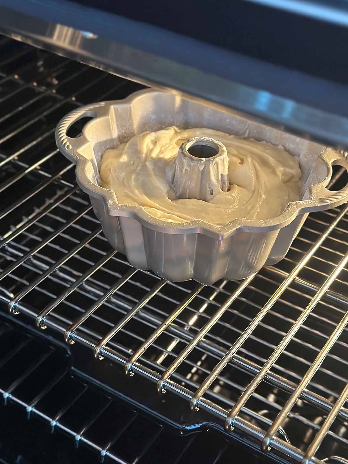 A bundt pan in the oven with an old-fashioned southern pound cake.